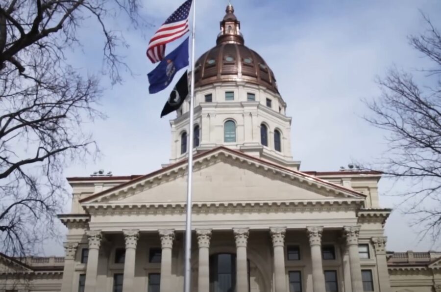 Kansas and USA flags waving in front of the building