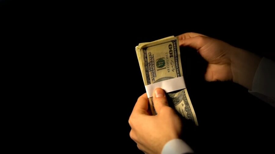 Hands Counting a Stack of U.S. Hundred-Dollar Bills, Symbolizing White-Collar Crime