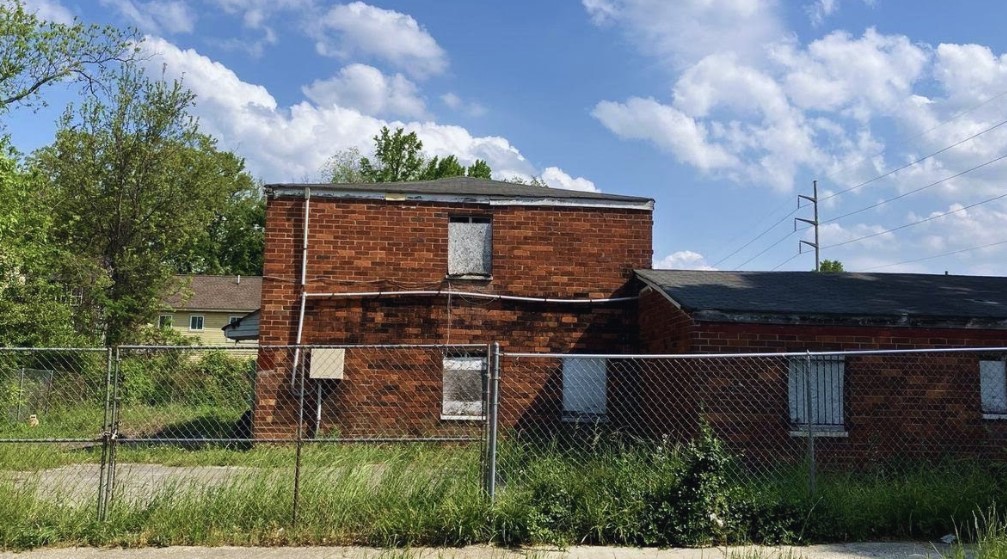 Brick house with a fence around it