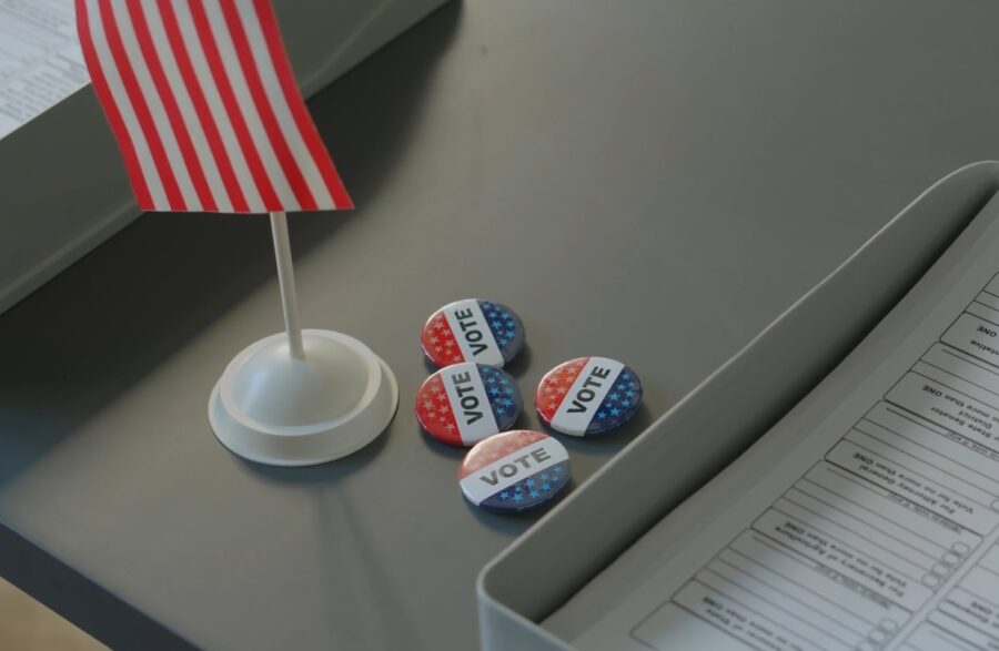 Voting station featuring a small American flag and several "Vote" buttons