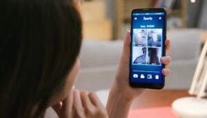 Woman looking at house cameras via phone