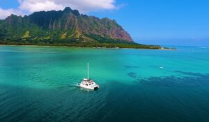 Boat on a water with mountains in the back