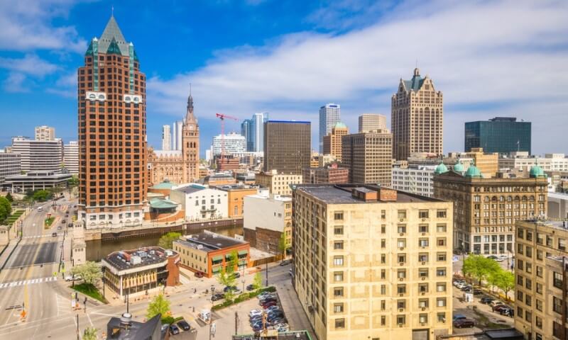 Aerial view of Milwaukee's skyline under a bright blue sky