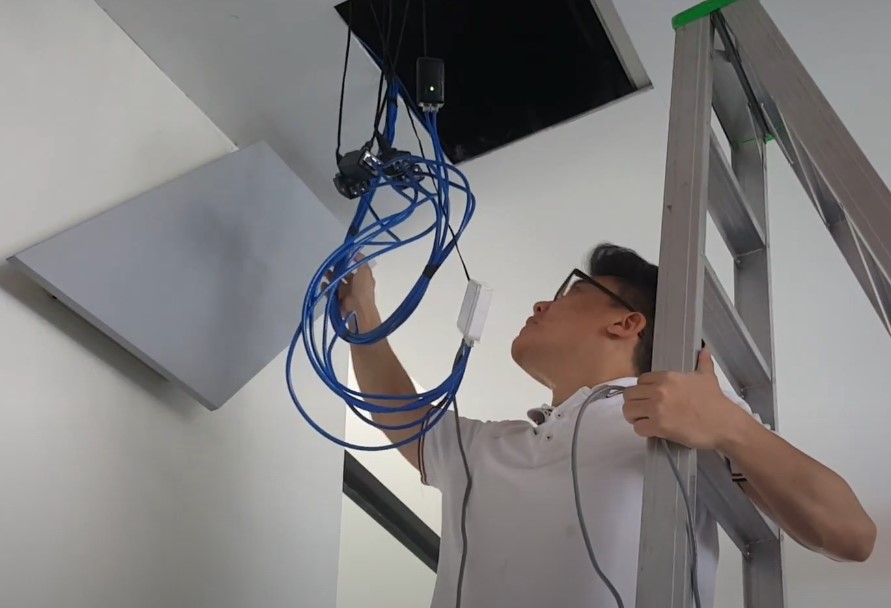 A man is installing CCTV camera in elevator