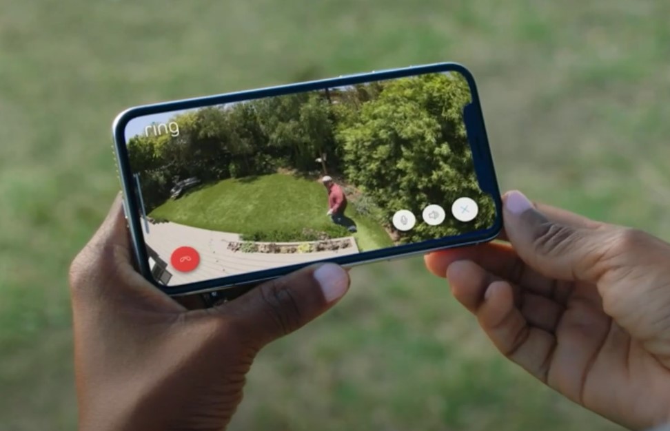 A woman watches live footage from the home camera