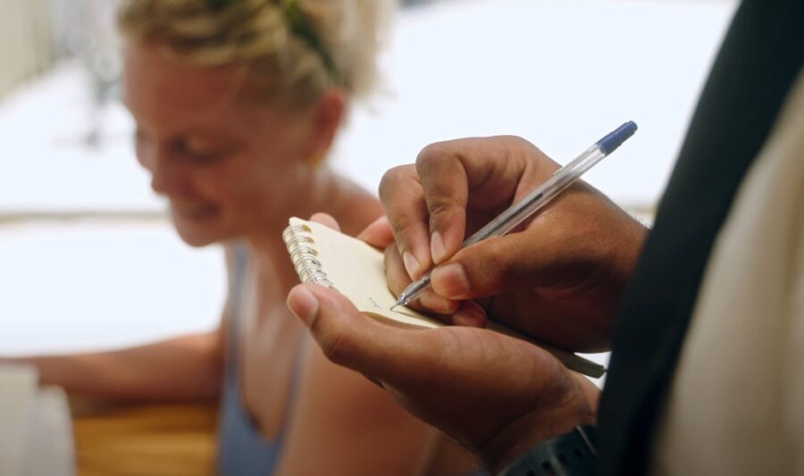 A waiter writing orders on a piece of paper