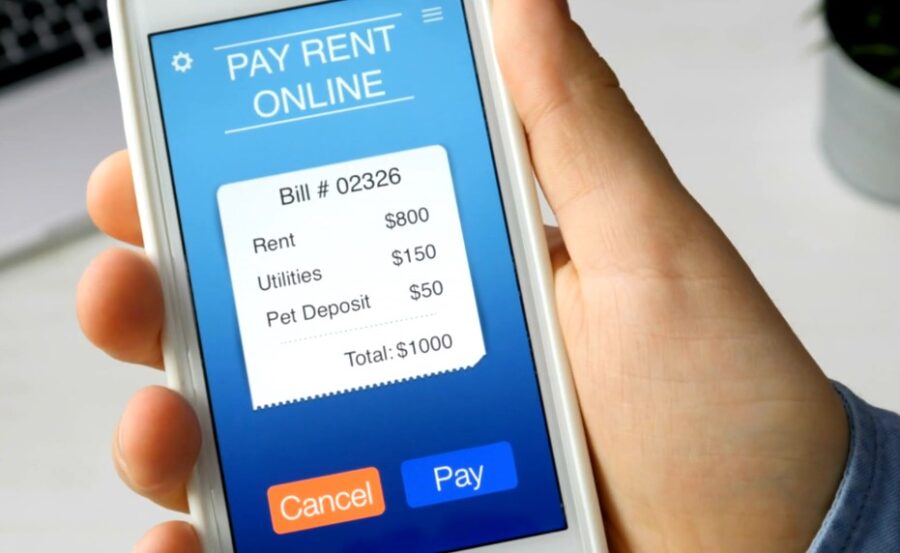 A person paying rent over phone