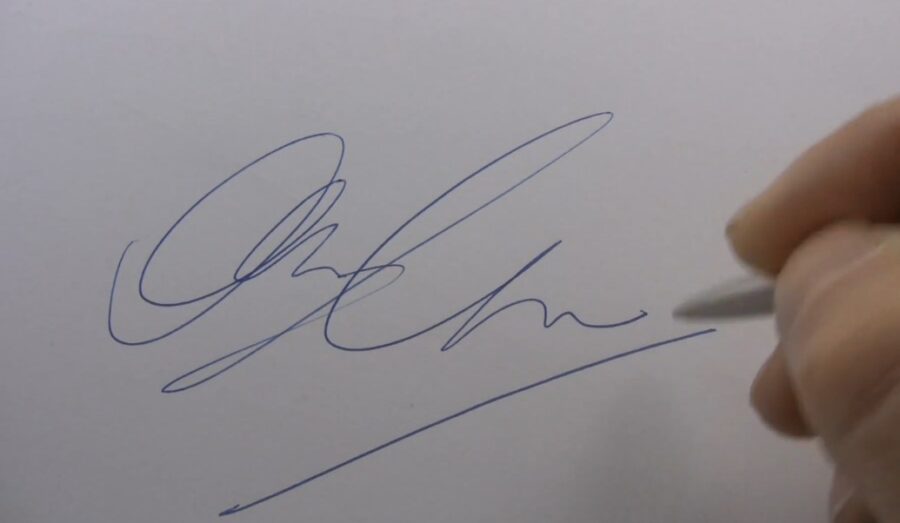 A close up of a signature on a paper