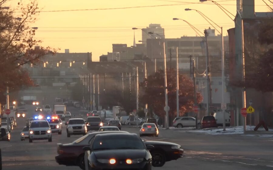 Police car in a busy traffic during sunset in North Philly