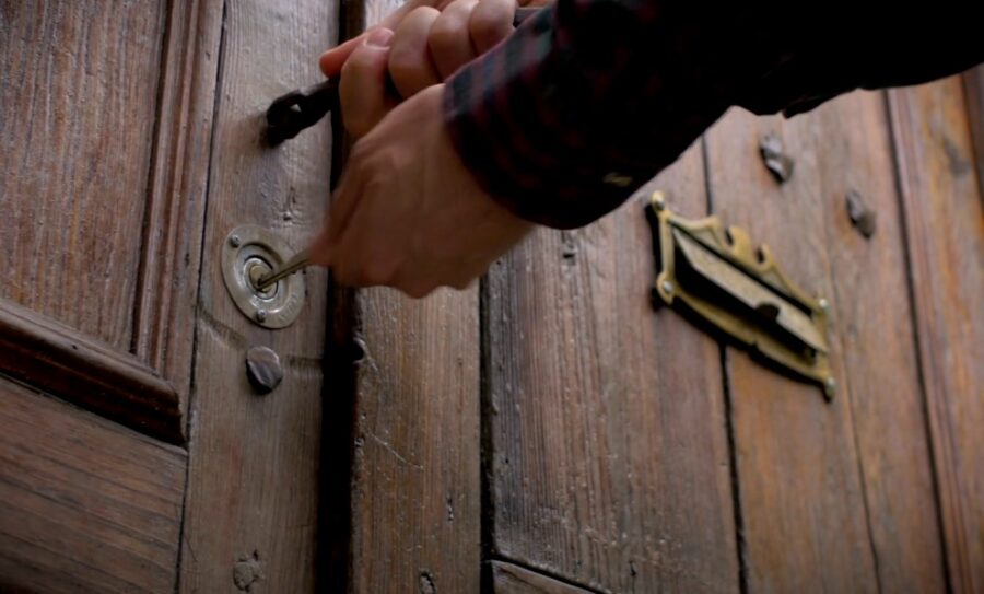 Man locks entry doors on a house