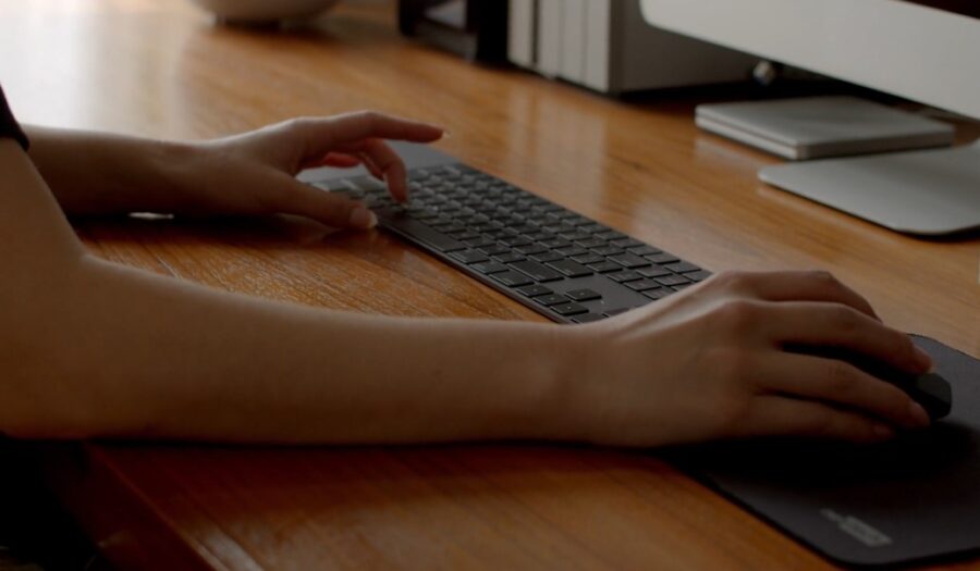 Girl freelancer using mouse and keyboard