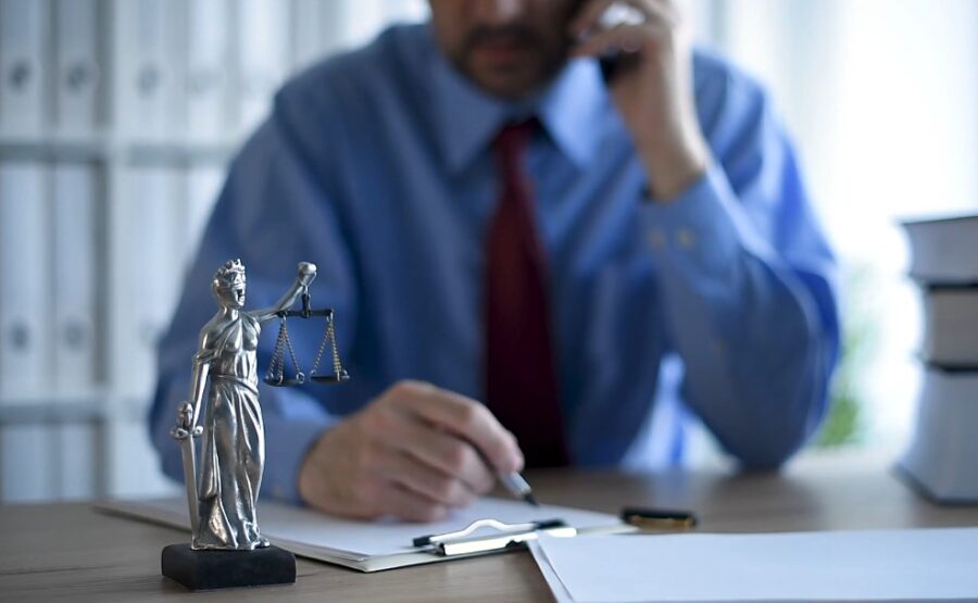 Attorney checking papers while talking on phone