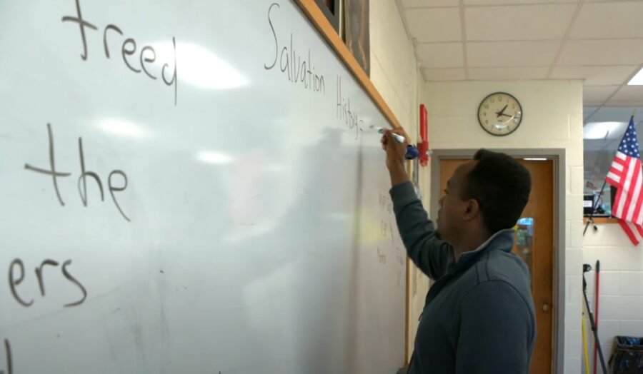 Student writes words on the whiteboard