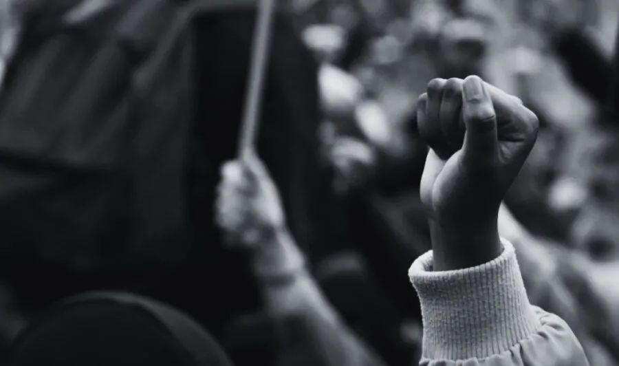 Black and white photo of a clenched fist during protest