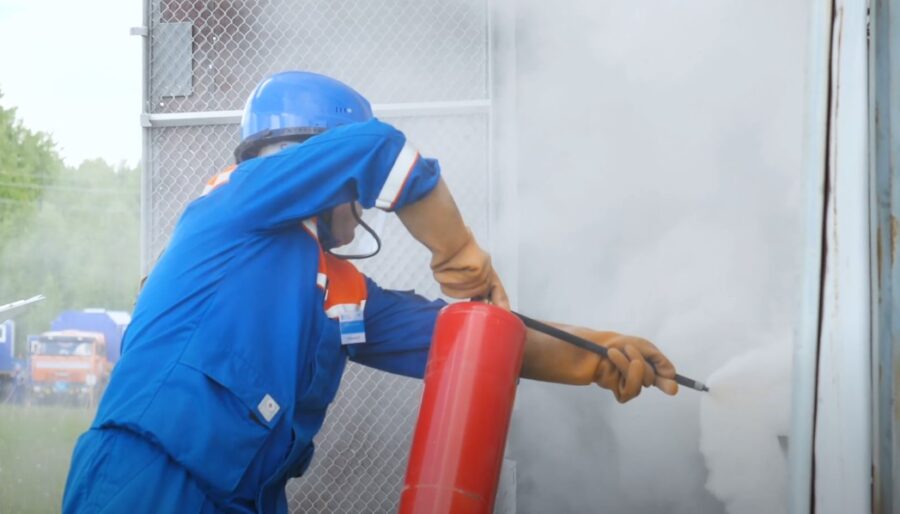 Fireman using a fire extinguisher to put out a fire