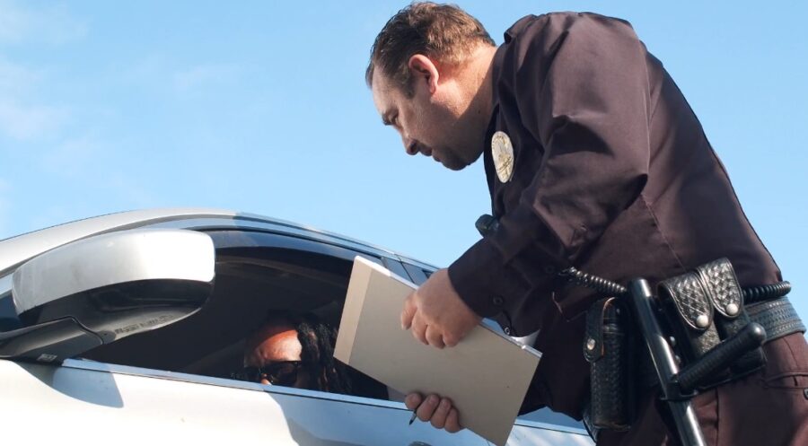 Police officer interacting with a person in a car