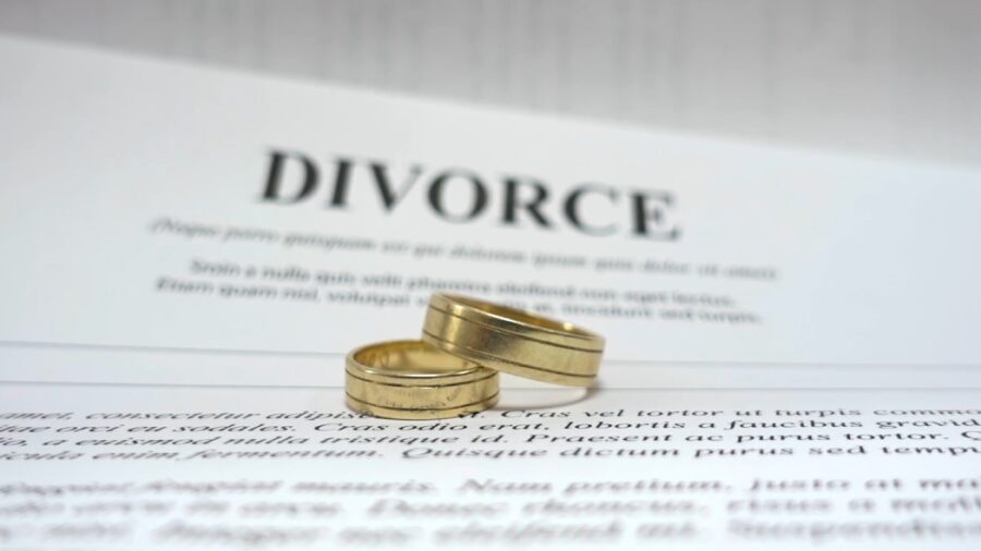 Two wedding rings on a divorce paper