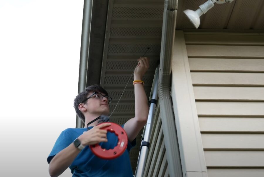 A person installing house security camera