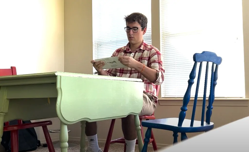 Guy voting by mail in his kitchen