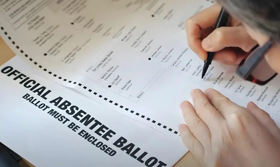 Person filling out ballot form