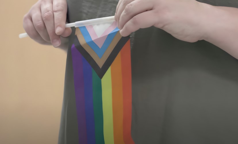 A person holds a trans pride flag