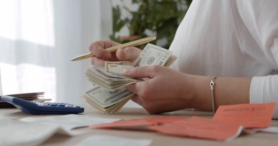 Close-up view of hands counting cash