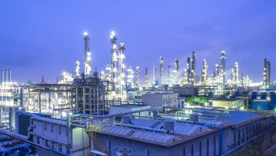 The petrochemical plant's vast expanse under a twilight sky