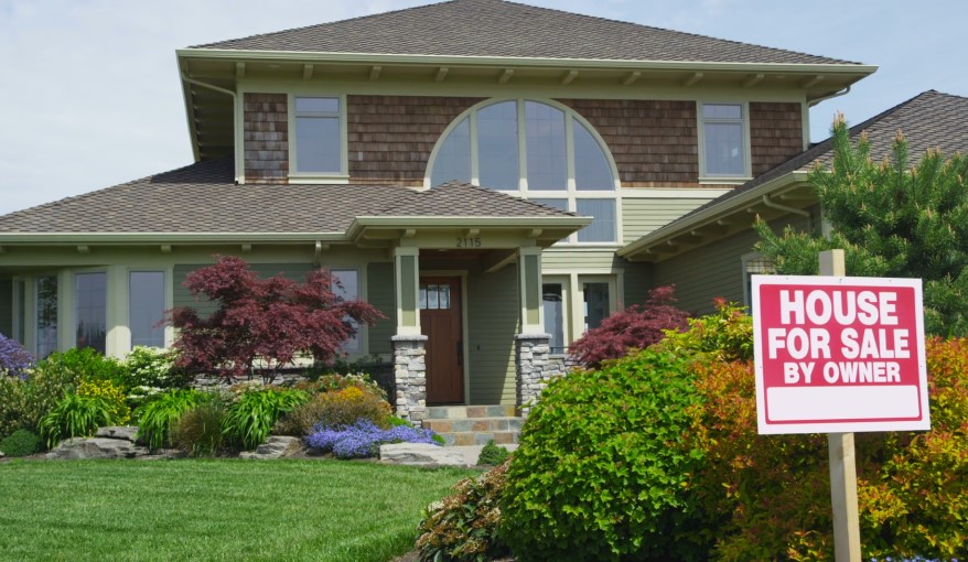 A charming house, with a "For Sale" sign