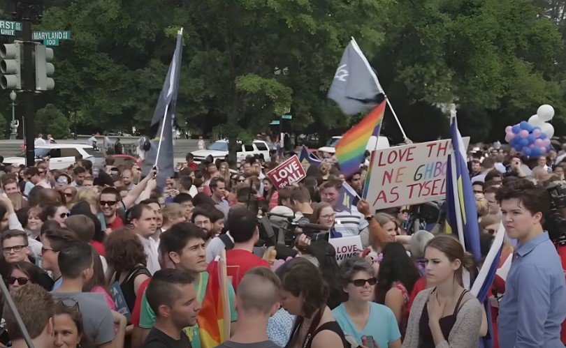 Diverse individuals, holding signs and flags