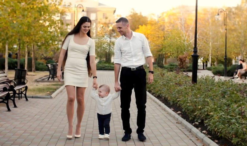 Parents and their toddler take a leisurely walk