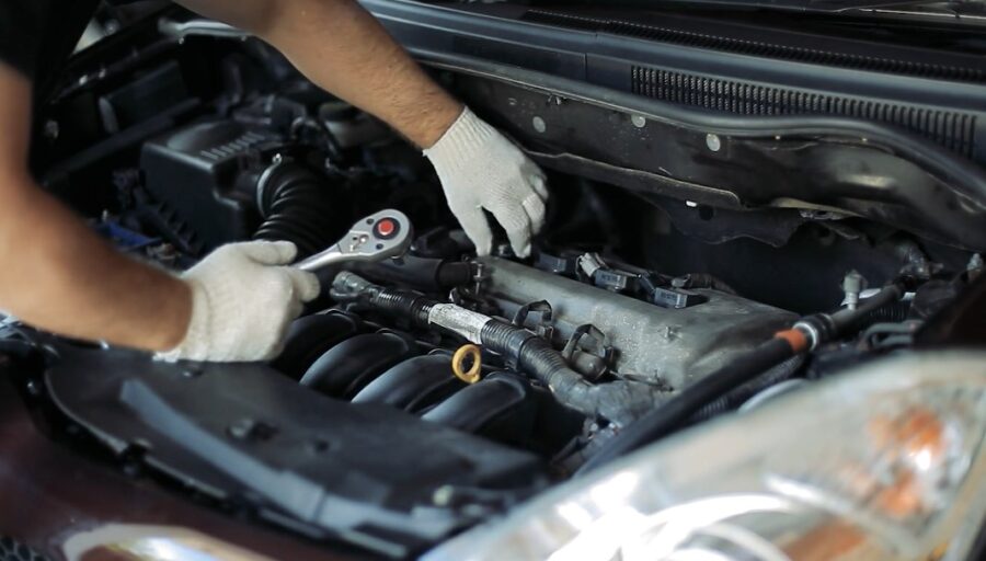 Expert hands meticulously work on a car engine