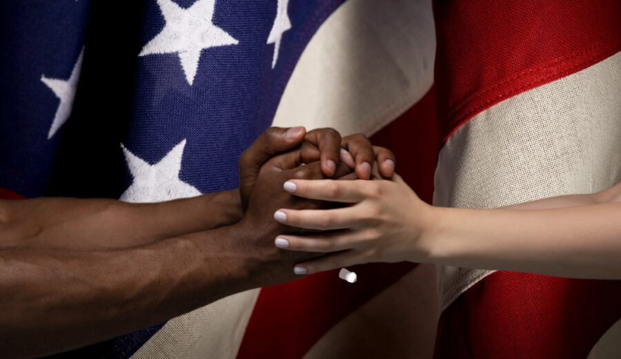 Two clasped hands, diverse yet connected, representing the strength of unity