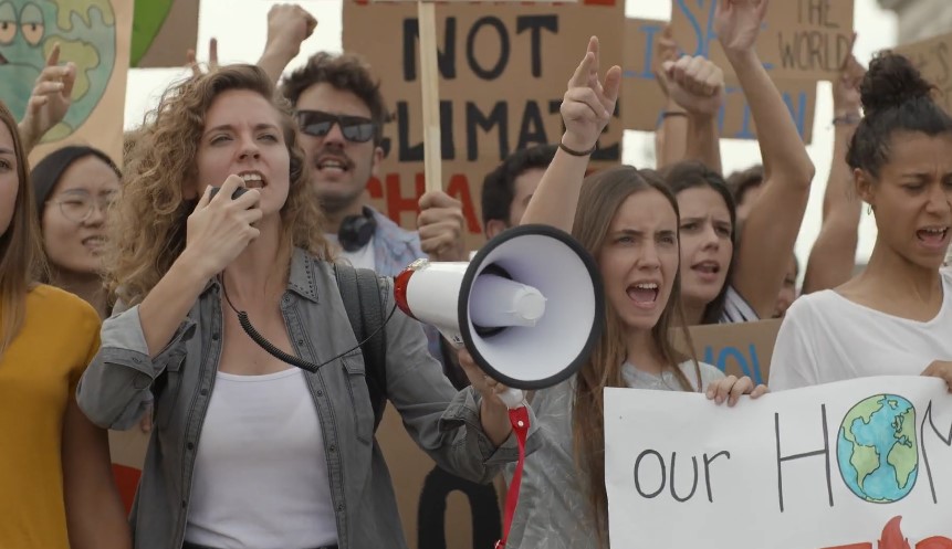 A diverse group of protestors, united in their voices against climate change