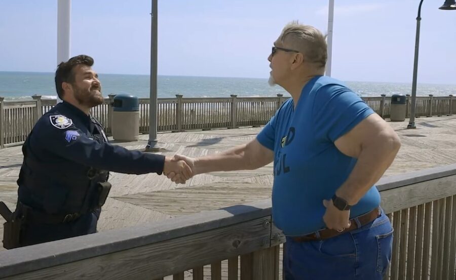 Officer and citizen shake hands