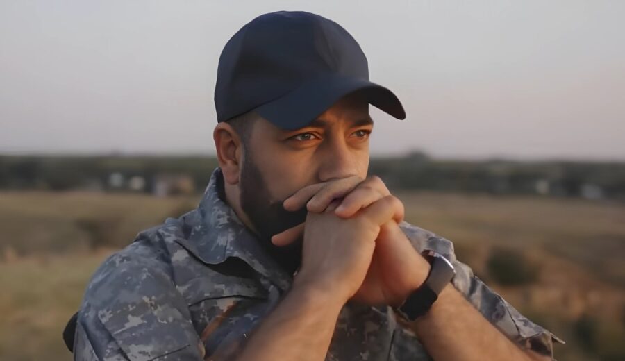 Military personnel in deep thought, outdoors