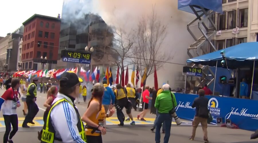 Emergency responders and spectators react to the disruption of the Boston Marathon