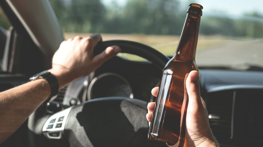 Driver holding a beer bottle behind the wheel raises the question: Is a DUI a felony or misdemeanor