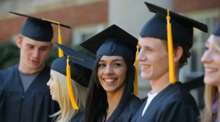 A group of smiling graduates poses together