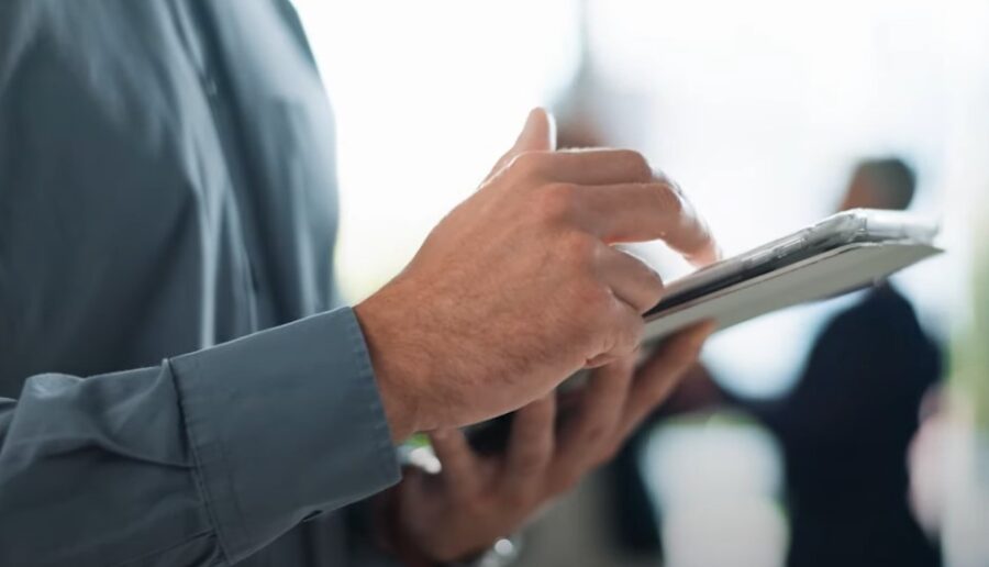 Focused hands interact with a tablet, conveying a sense of focused work