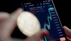 A mobile phone displays real-time cryptocurrency trading data