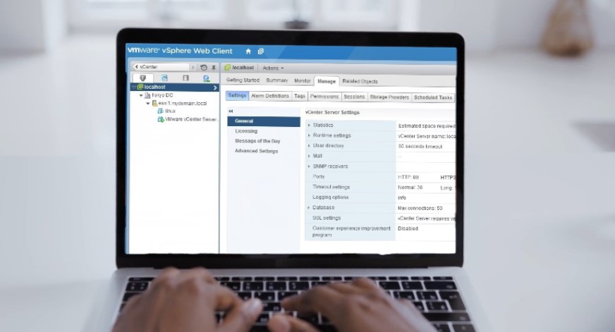 A laptop screen displays VMware vSphere Web Client settings
