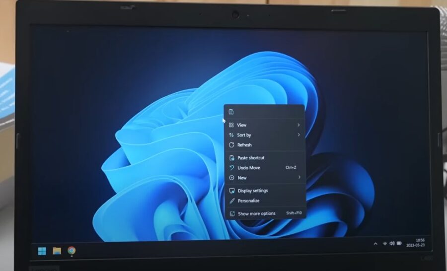 A Windows 11 laptop screen displays a menu of options