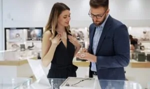 A woman and man browse jewelry in a store