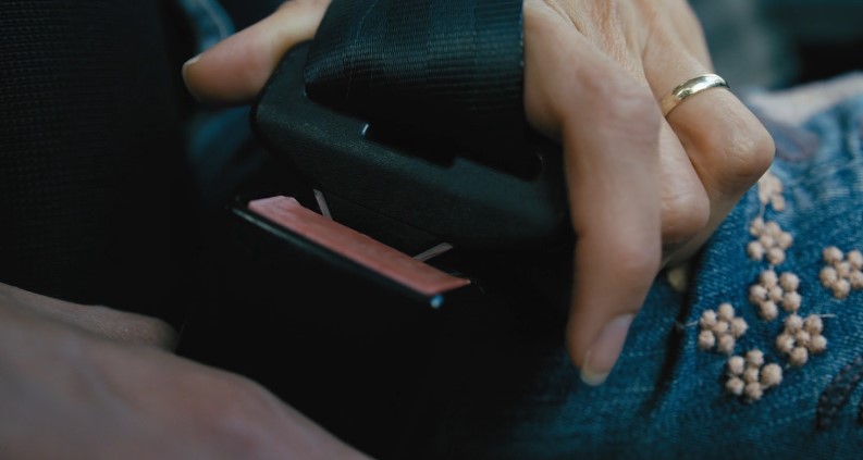 Close up view of a woman's hand putting seat belt