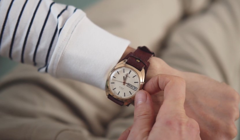 Close-up of a person checking the time on a wristwatch