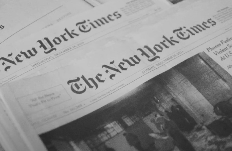 Stacked New York Times newspapers