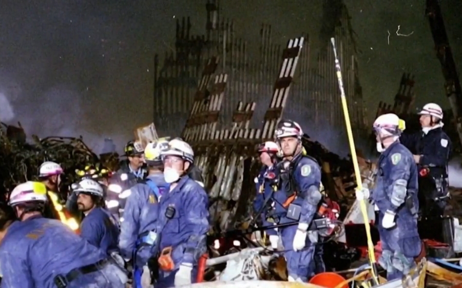 Rescue workers search through debris at Ground Zero following the 9/11 attacks
