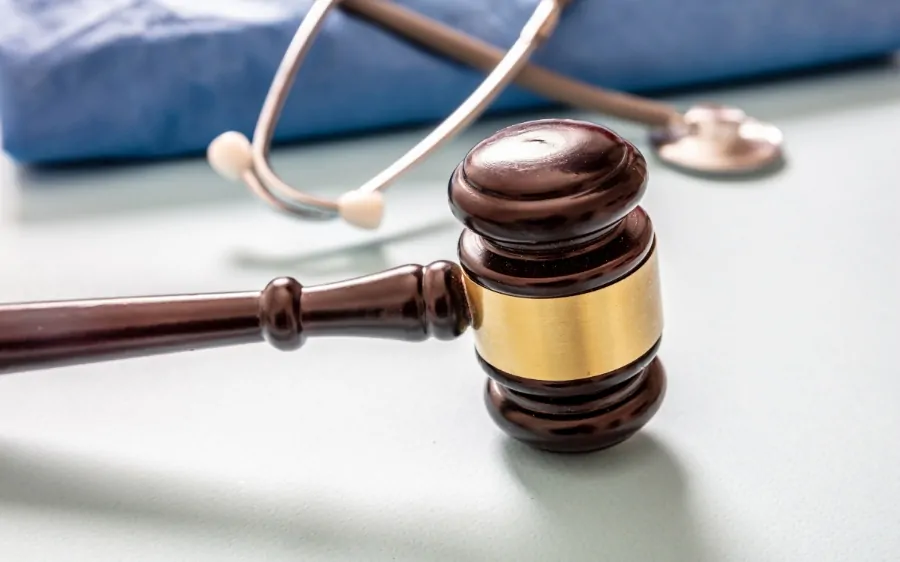 A judge's gavel and stethoscope on a table represent legal action tied to major personal injury settlements in the U.S.