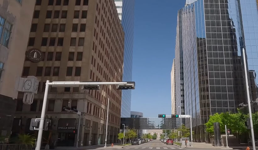 A bustling city street, lined with towering buildings, showcasing the urban landscape