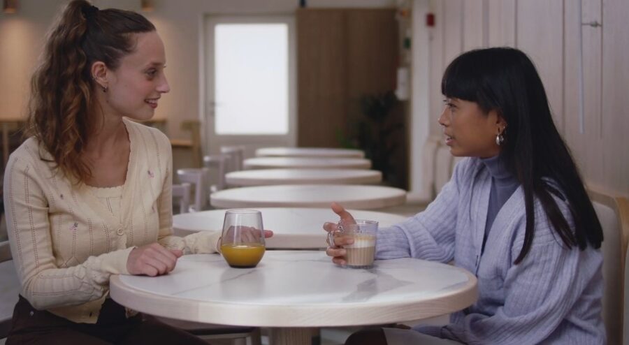 Friends talking while drinking coffee